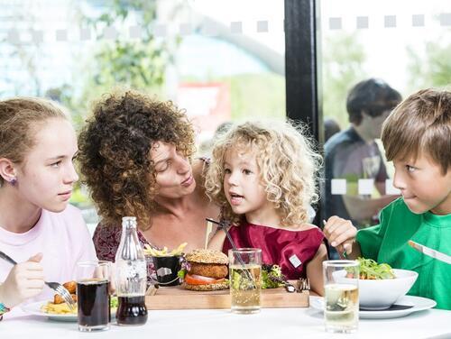 Family sitting at table eating together