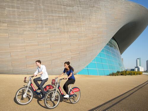 Two people ridings bicycles along