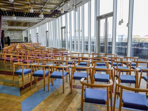 A space set up for a speech or conference with seating for a large audience