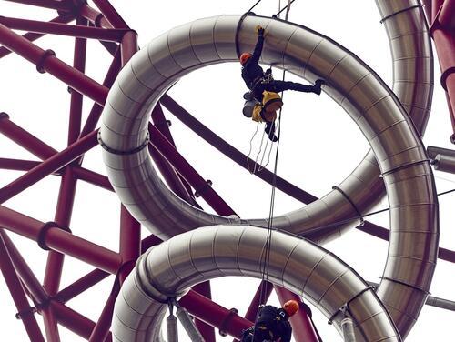 Abseilers cleaning the slide