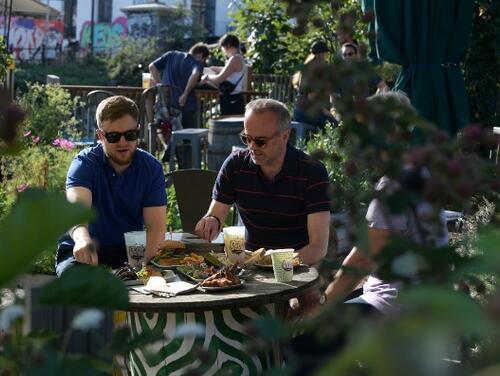 People eating in Barge East's gardens