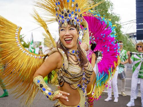 a person with crown and wings in a parade Great Get Together