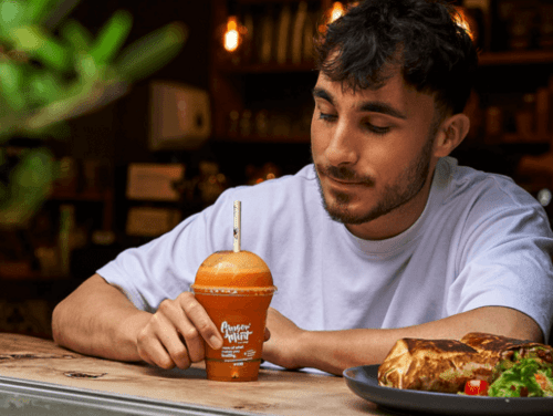 A man enjoying an orange juice and lunch