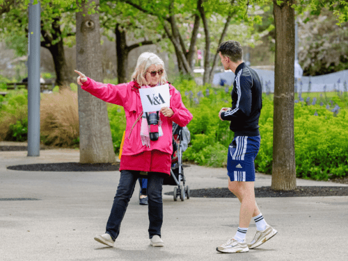 Volunteer directing a park guest