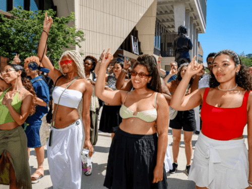 Young women enjoying music in a crowd