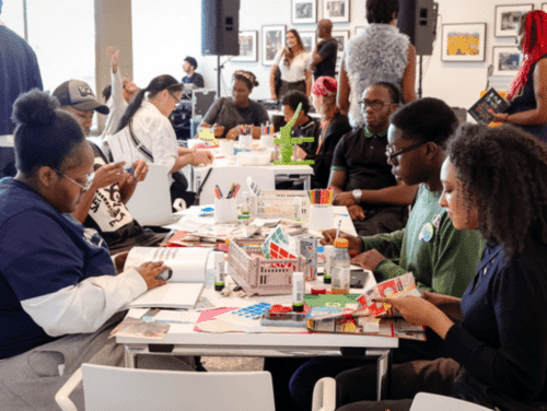 A group of people in a zine making workshop