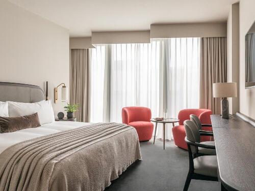 A hotel room with grey and pink interiors