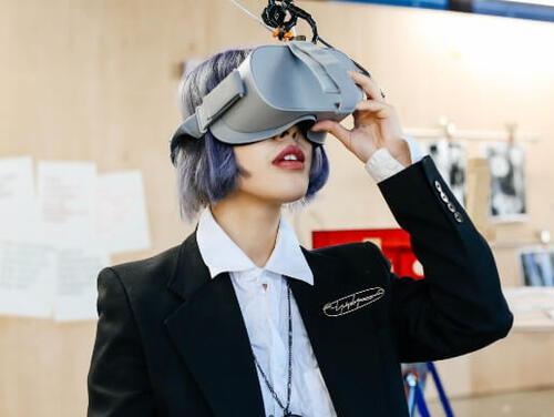 A woman wears VR goggles