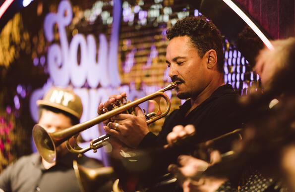 A brass player performs on stage