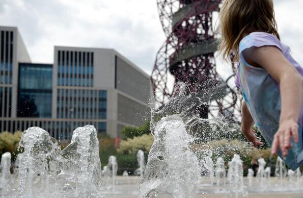 Child playing at the fountains