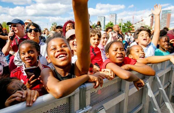 Children enjoying acts at the Great Get Together at Queen Elizabeth Olympic Park