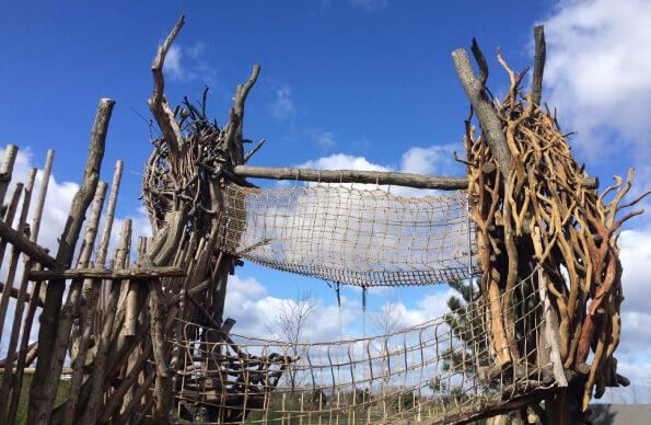 Tumbling Bay Playground with tall wooden structures with a rope bridge between