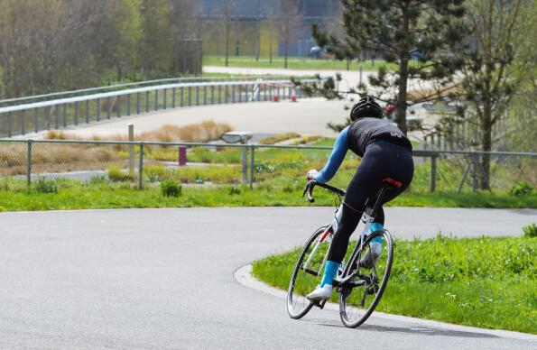 A single cyclist turns a corner on the road track at Lee Valley VeloPark