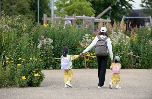 Woman walking with two children