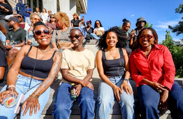 4 people smile at the camera at The Music is Black Festival