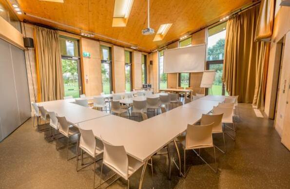Inside Timber Lodge Cafe showing a seating set up ready for a board meeting or corporate presentation