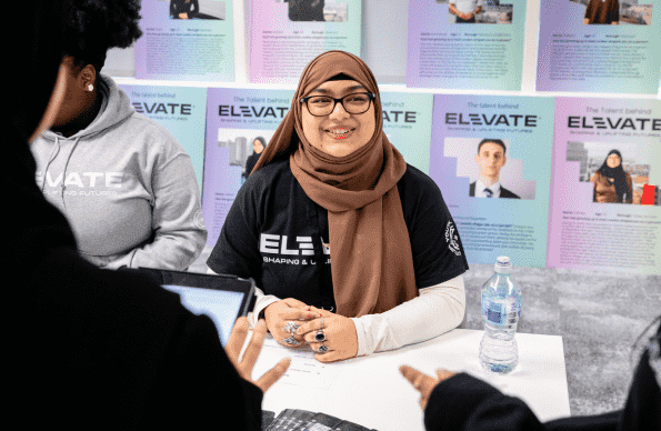 Woman in hijab talking over table