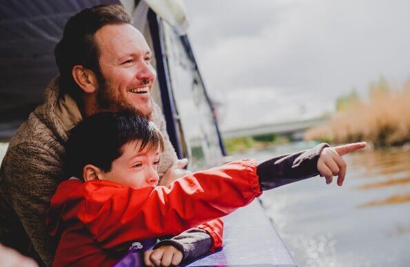 Man and his son on a boat tour