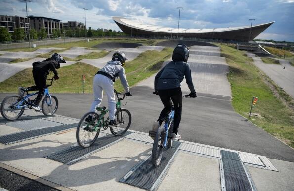 3 children preparing to cycle round the BMX track at Lee Valley VeloPark