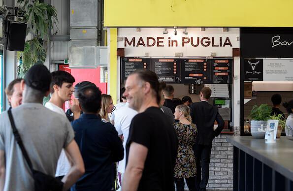 A line of people wait for pizzas from Made in Puglia at Hackney Bridge