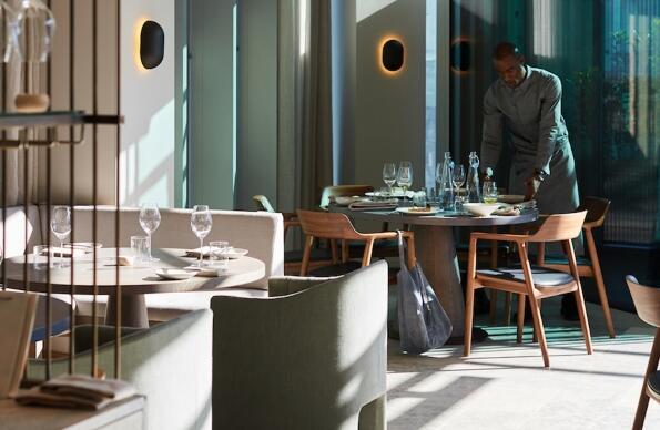 A waiter sets a table at a cocktail bar