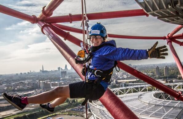 A woman abseiling down ArcelorMittal Orbit A woman abseiling down ArcelorMittal Orbit