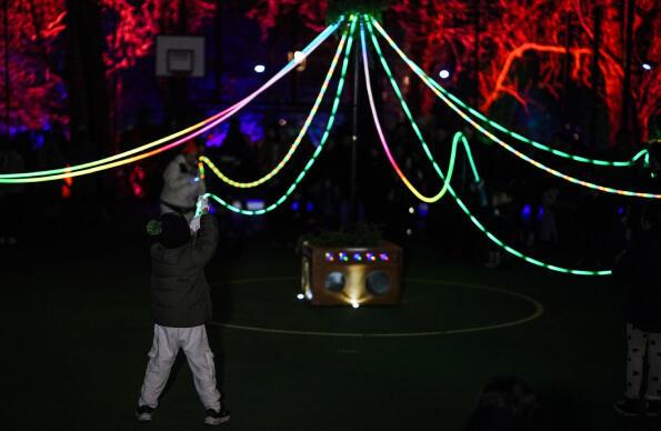 BASSTONE PLAYGROUND with people holding light strings