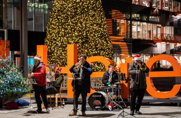A brass band plays at Here East