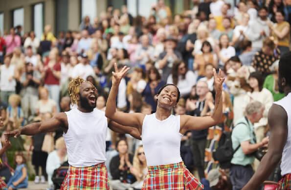 Two dancers in front of a large crowd Two dancers in front of a large crowd