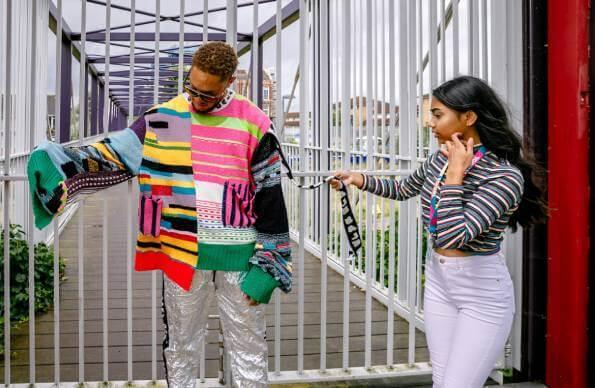 A student at LCF fashion course at East Summer School, dresses a model in a colourful jumper A student at LCF fashion course at East Summer School, dresses a model in a colourful jumper
