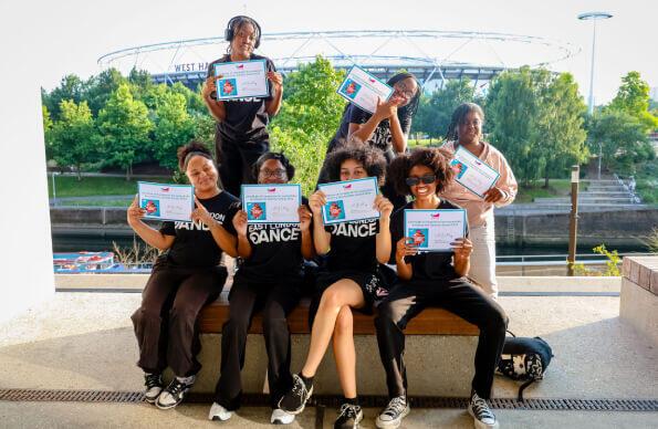 Students hold up their certificates at East Summer School Students hold up their certificates at East Summer School