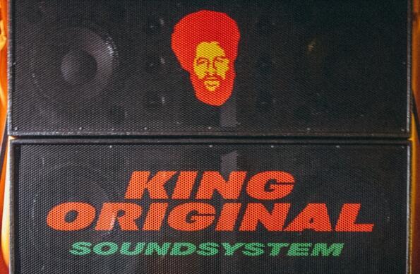 A large soundsystem with printed text and a face