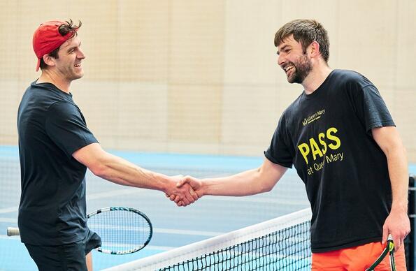 Two tennis players shaking hands after a match