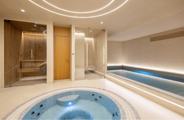 Inside a spa, showing two pools, sauna and steam room