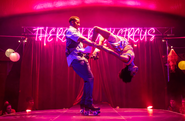 Performers on roller blades do a flip