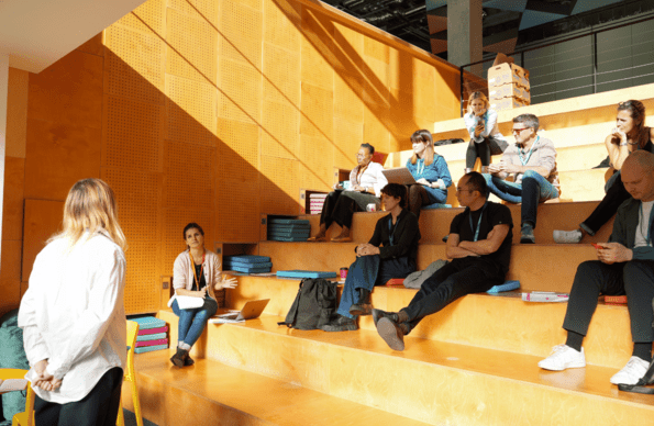 People talking in a theatre style room