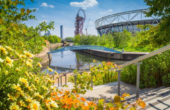 Plants and flowers in front of a river at Queen Elizabeth Olympic park