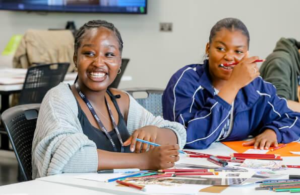 Two young people at a class of East Summer School