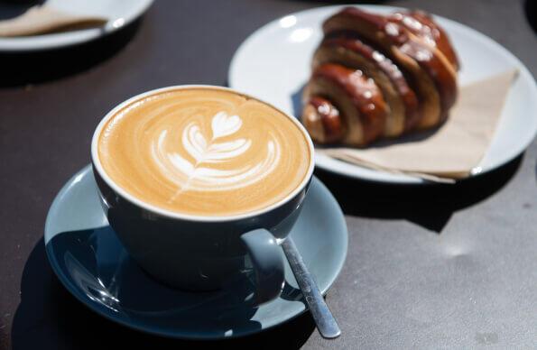 A coffee and pastry behind from Timber Lodge Cafe