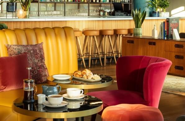 Velvet seating and breakfast in a hotel bar