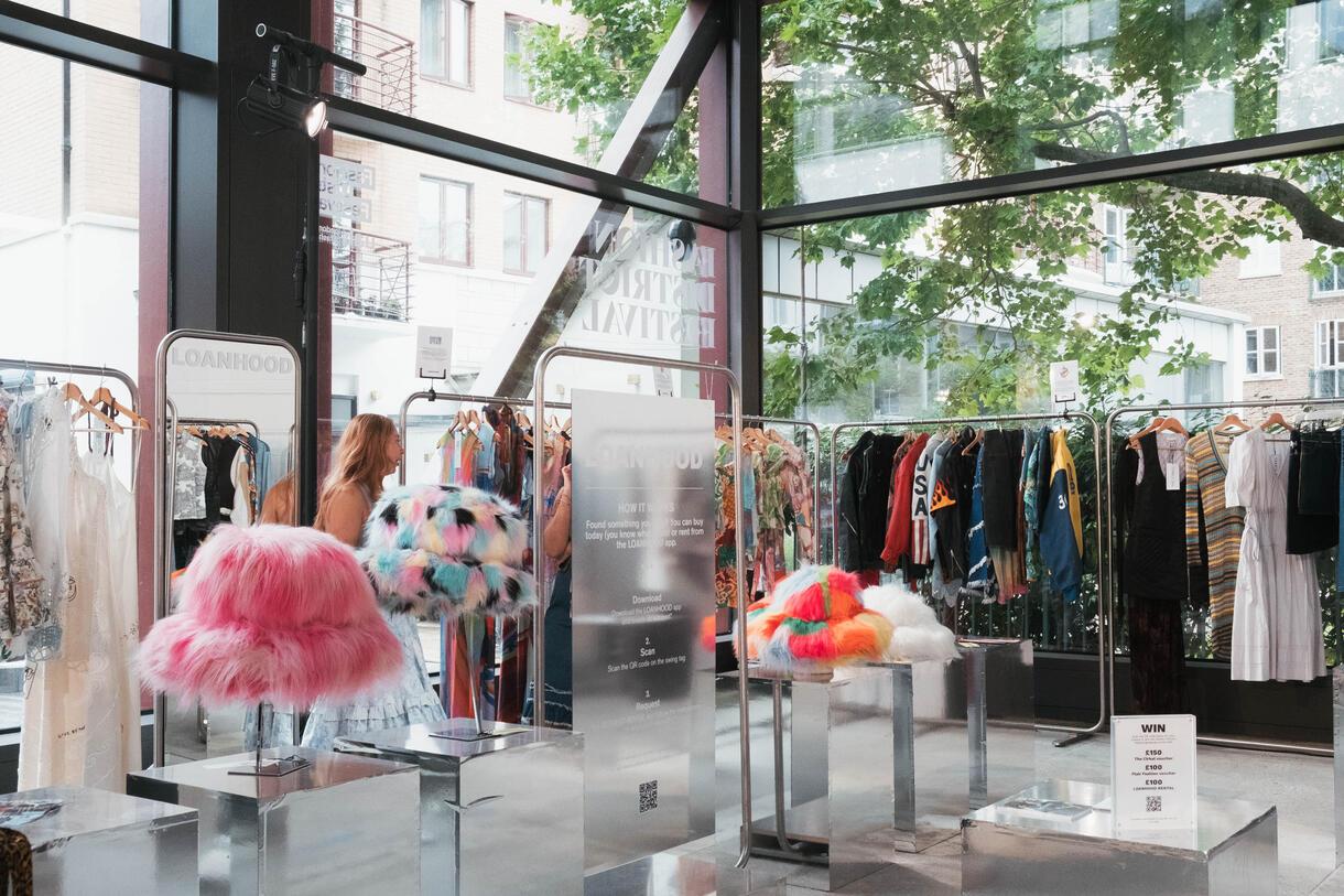 A showroom showing colourful fashion and fluffy hats