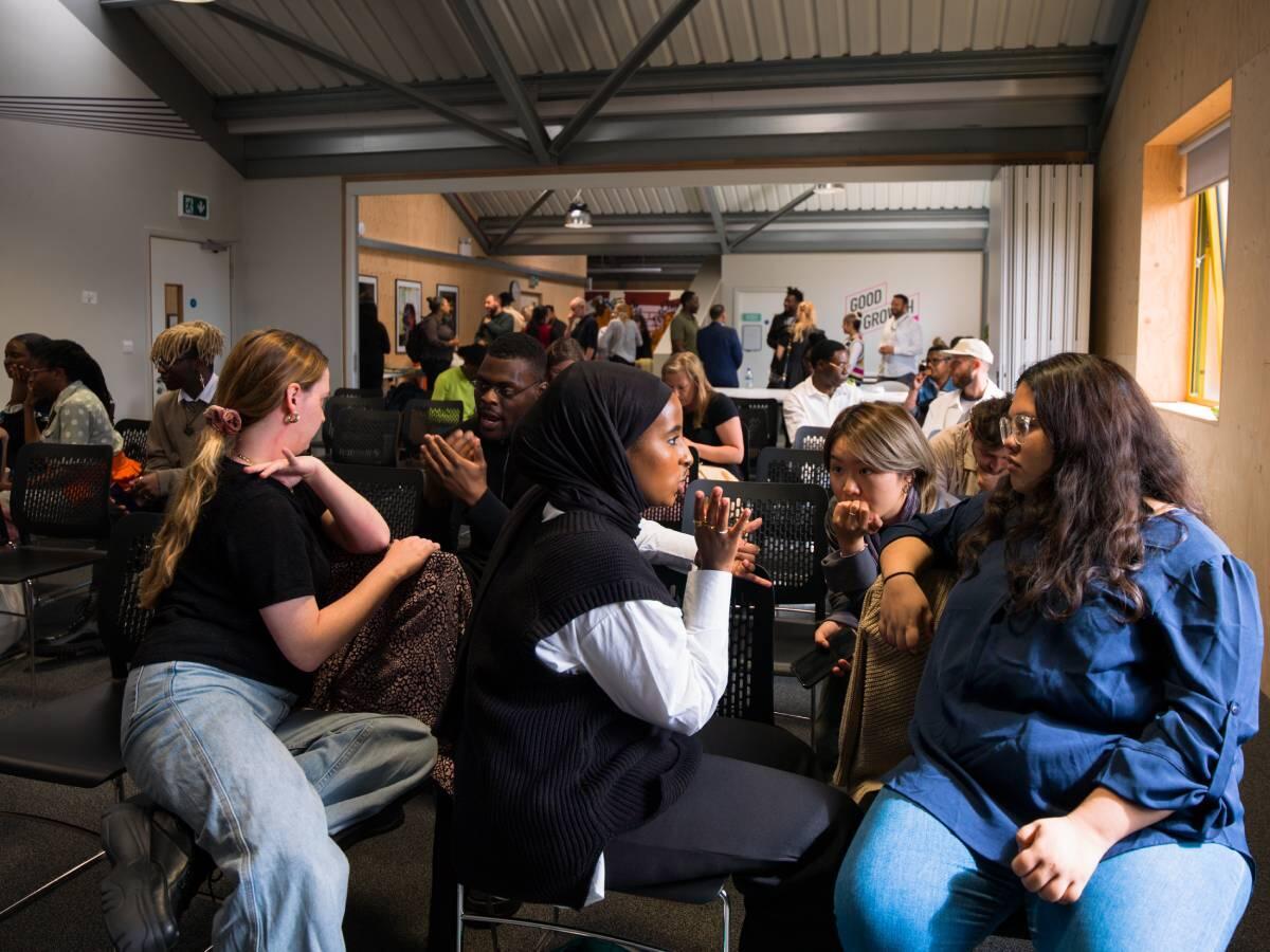 People sitting and talking in a large room