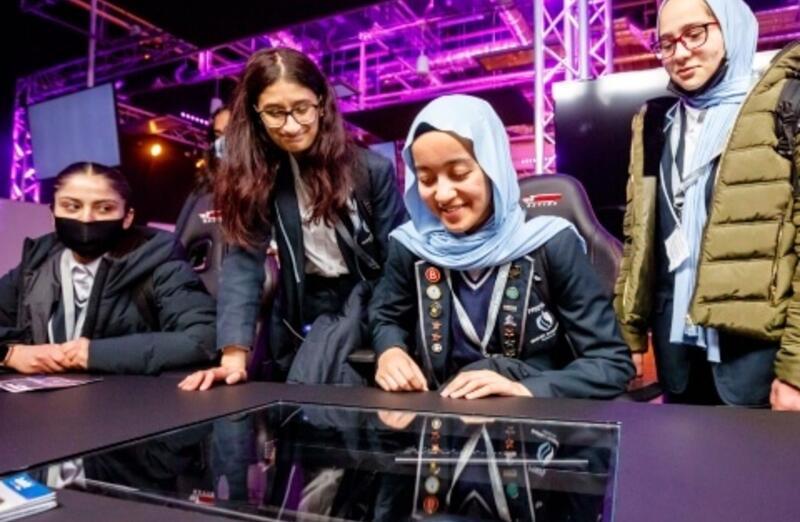 Three girls learning from a teacher