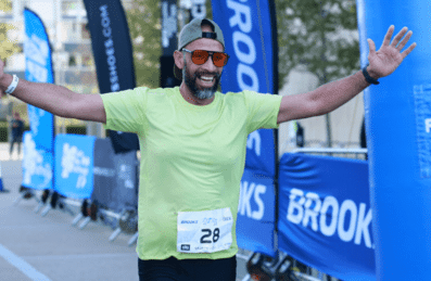 A runner crossing the finish line at Aquathon running event