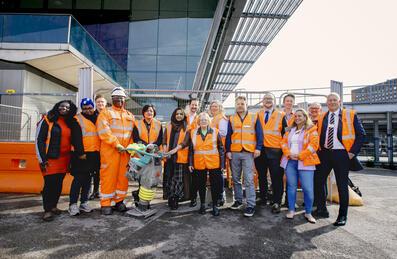 Group of people standing near carpenters entrance Stratford station
