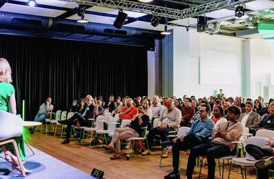 A panel of speakers in front of a crowd at Future Talks event