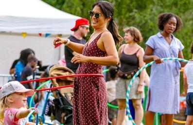 Woman enjoying hula hoops at The Great Get Together