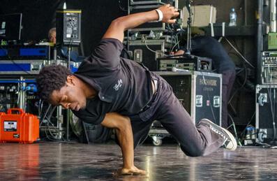 A hip hop dances performs on a stage