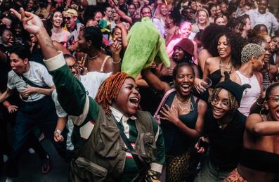 A group of people dance in a crowd