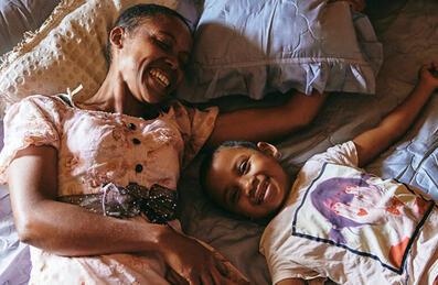 Two people lie down laughing